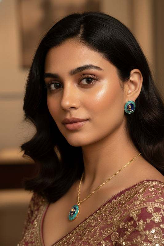 Woman wearing a gold necklace and earrings with a blurred background