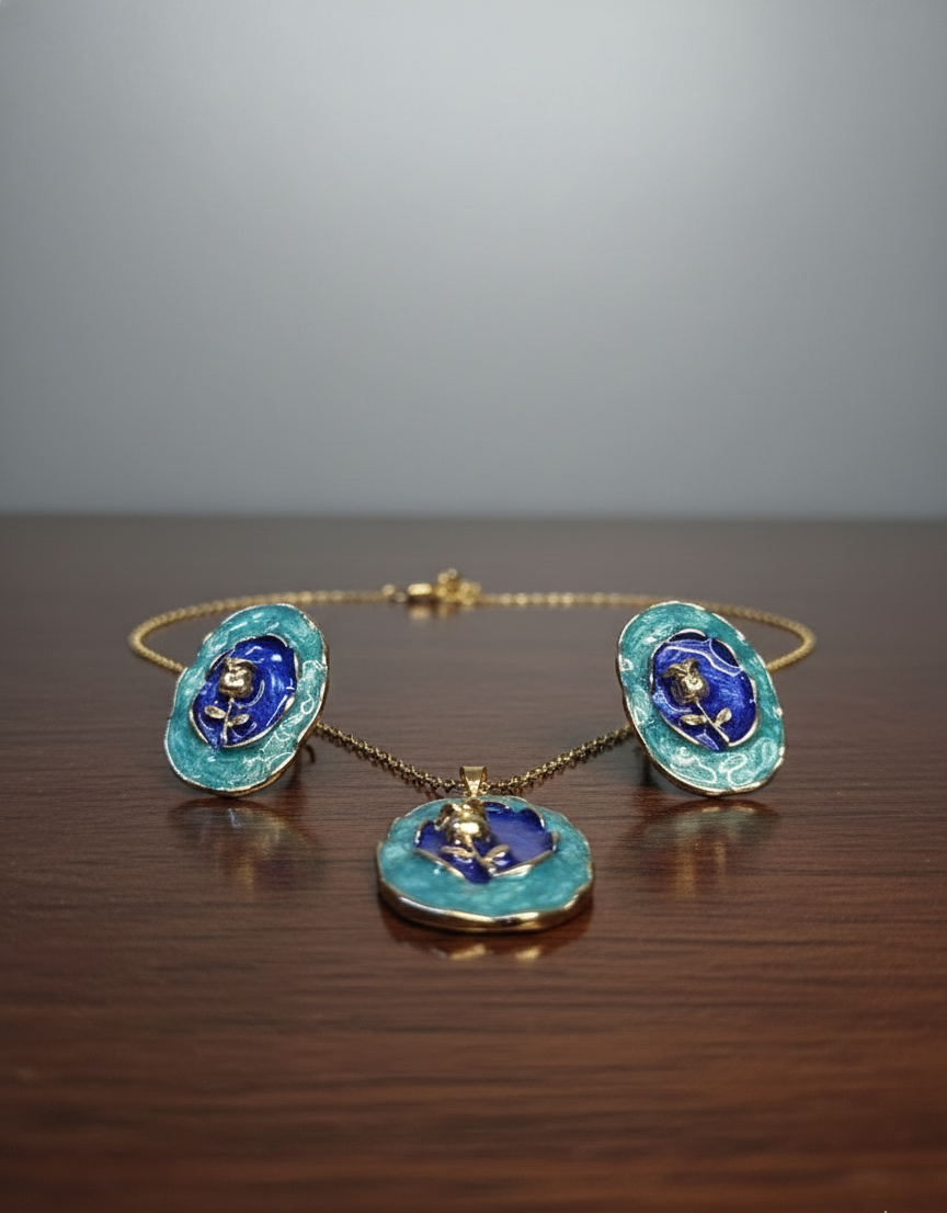 Jewelry set with blue floral designs on a wooden surface