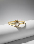 Gold bracelet with a central pearl on a white surface