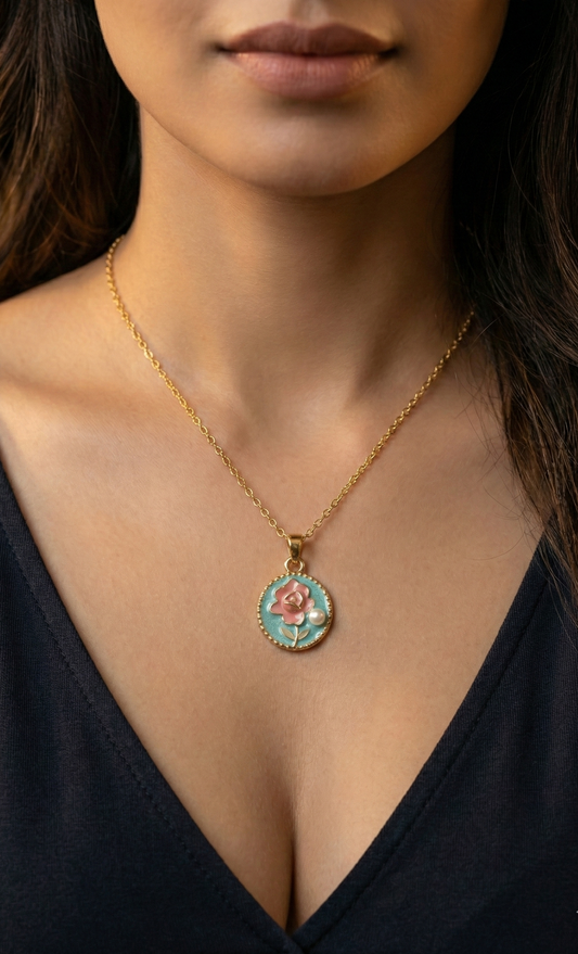 Necklace with a pendant featuring a rose design worn by a person in a black top.