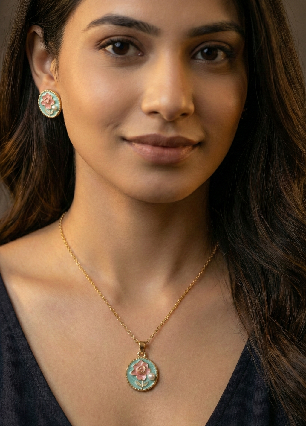 Woman wearing a gold necklace with a pendant, close-up portrait.